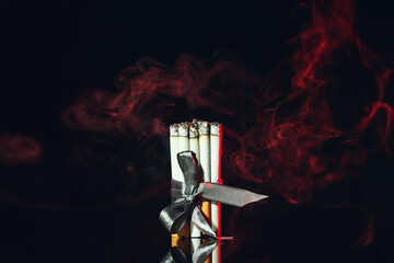 Many cigarettes on dark background. Concept of addiction