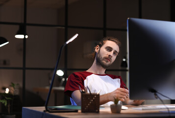 Handsome man working in office at night