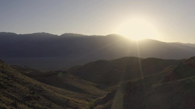Flying over foothills at sunrise.