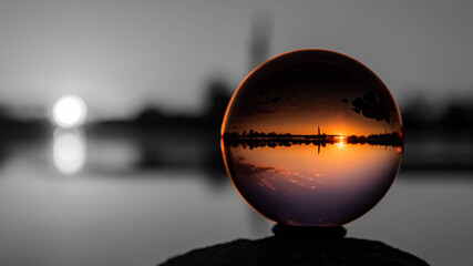 Crystal ball sunset shot with black and white background outside the sphere near Pleinting, Bavaria, Germany