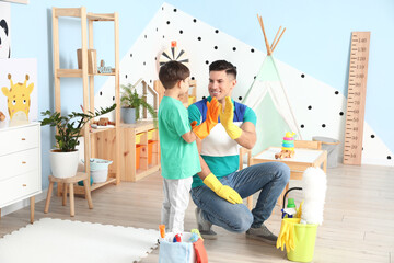 Father and son giving each other high-five at home