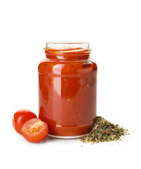 Glass jar of tasty tomato sauce and spices on white background