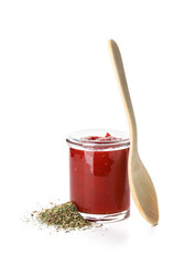 Glass jar of tasty tomato sauce and spices on white background