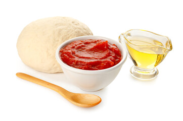 Bowl of tasty tomato sauce, oil and dough on white background