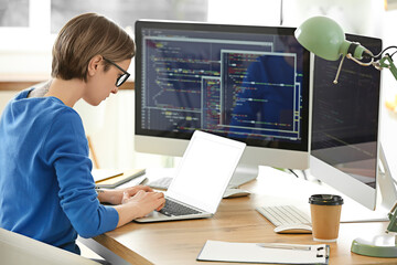 Female programmer working with laptop in office