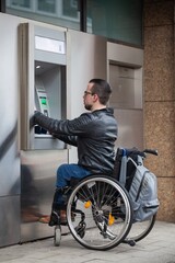 man in wheelchair using atm bank machine