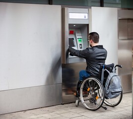 man in wheelchair using atm bank machine