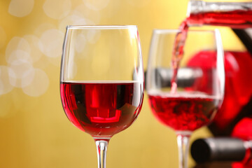 Glasses of tasty red wine on blurred background, closeup