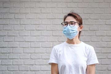 Woman wearing medical face mask, prevent coronavirus or Corona Virus Disease (Covid-19). Health concept