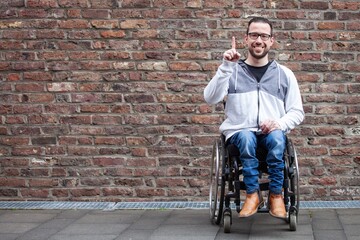 Fototapeta na wymiar man in wheelchair counting on his fingers