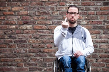 man in wheelchair giving the middle finger