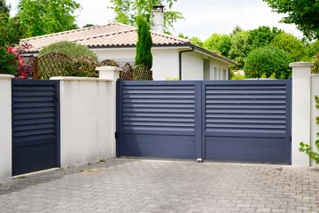 Fotobehang modern wicket and grey gate of home aluminum portal suburb door in house © OceanProd
