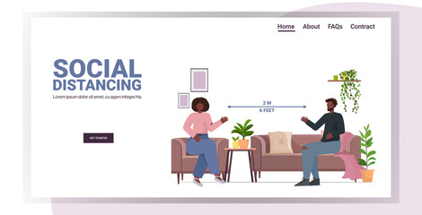 couple discussing at home man woman keeping distance to prevent coronavirus social distancing