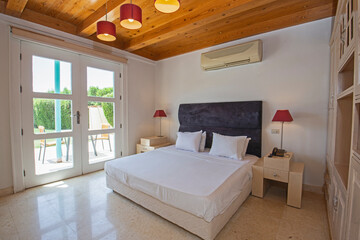 Interior design of double bedroom in house with patio terrace