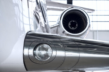Luxury private jet plane storage inside the hangar. Natural black and white high contrast. 