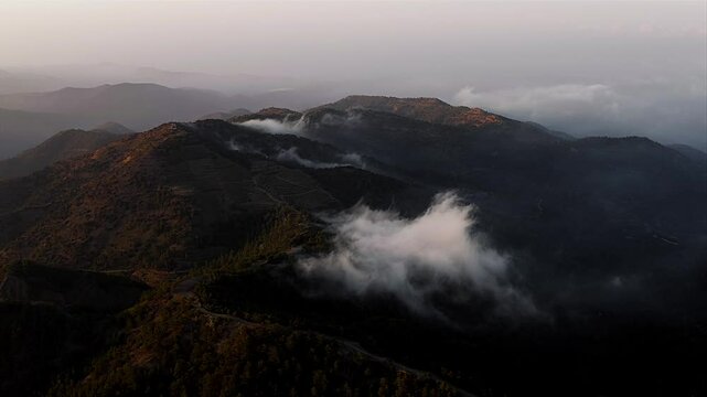 Troodos mountain landscape with low clouds at sunset