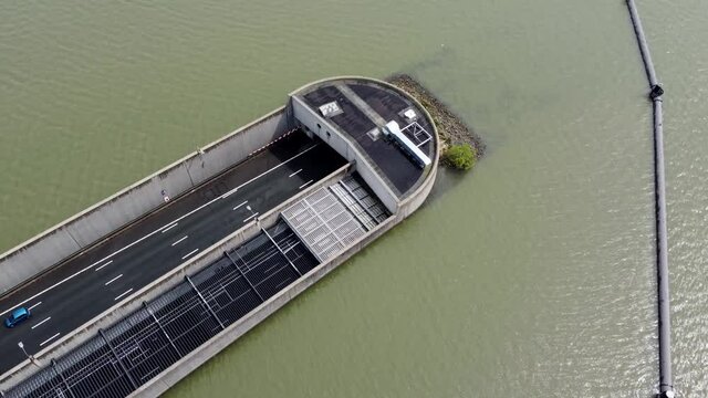 Aerial view of highway tunnel going underwater showing traffic moving in both ways located in The Netherlands which is well known for its innovative water management and infrastructure solutions 4k