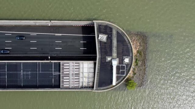 Aerial moving over highway tunnel going underwater showing traffic moving in both ways located in The Netherlands which is well known for its innovative water management and infrastructure solutions