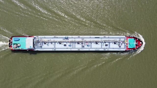 Aerial top down view of tank barge is vessel that is used to carry liquids solids and gas through waterways and rivers and across areas of ocean an essential player in energy and offshore industries