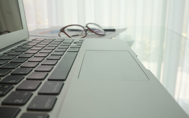 Works space with laptop and glasses put on the chart paper, concept work form home 