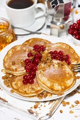 delicious pancakes with berries and honey for breakfast, vertical