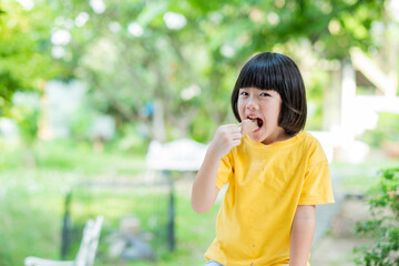 Fototapeta premium asian girl eating ice cream with blur background