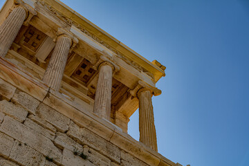 Fototapeta premium Low angle view of the front of the Athena Nike Temple with ancient columns on the Acropolis in Athens, Greece