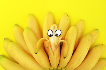 Bunch of small bananas, middle banana with toy google eyes