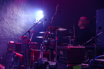 Drummer playing the drums show on stage. Rock concert show set up.