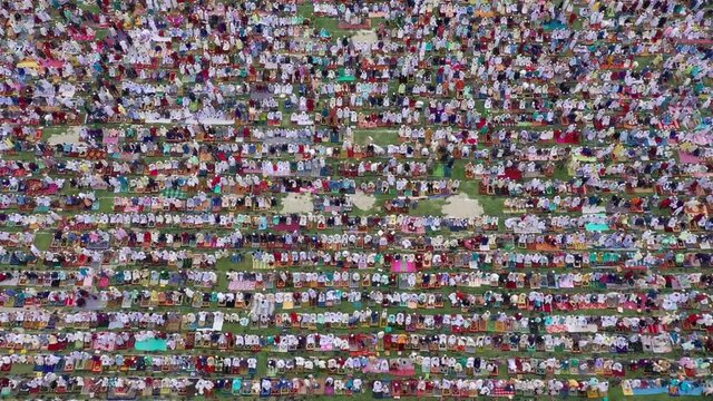 Aerial view of a vast crowd of people worshipping at Gore Shahid park in front of Eid Gah Minar religious site in Dinajpur, Rangpur, Bangladesh.