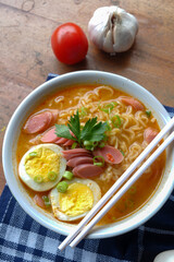 Photo of noodle soup with toppings such as sausages, eggs, and vegetables
