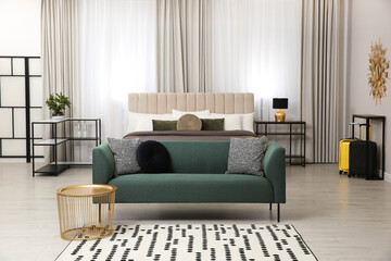 Beautiful hotel room interior with green sofa