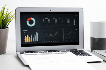 Laptop with  graph chart report screen on work table. Home office or work space. Strategy analysis financial accounting concept