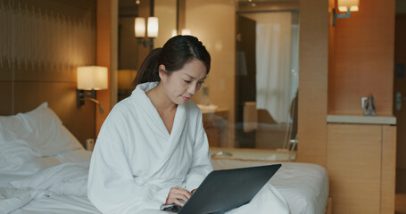 Woman work on laptop computer at hotel room