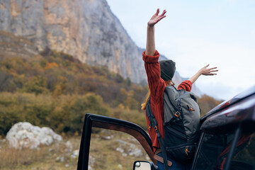 woman travels in the mountains near the car trip journey