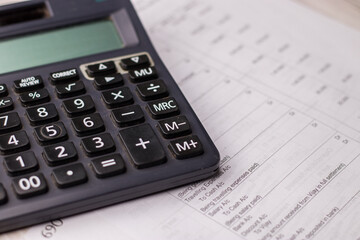 Black calculator on texture background stock image.