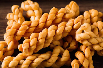 close up of fried dough twist on wooden table