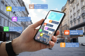 Tourist using online guide application on smartphone for navigation in city, closeup. Augmented...