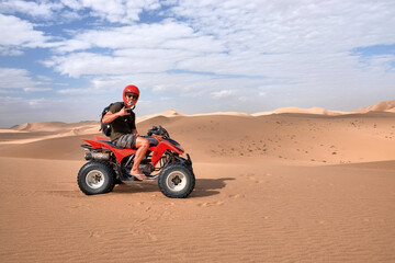 man with quad bike in the namib desert © jordi