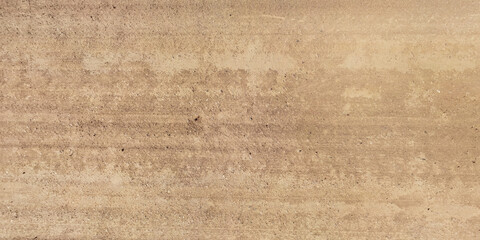 panorama of road from above on surface of gravel road with car tire tracks