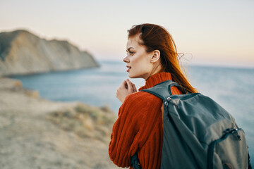 a traveler with a backpack are resting in the mountains in nature near the sea