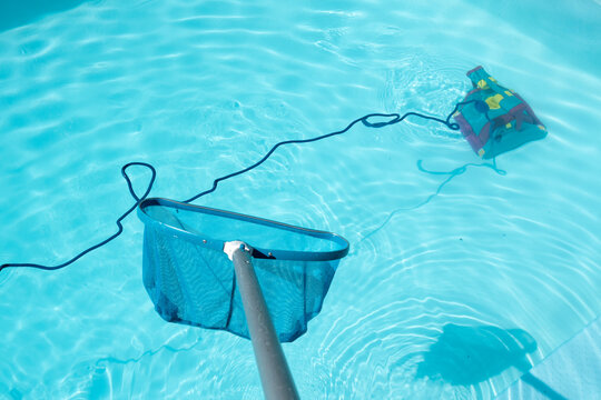 Swimming Pool Cleaning With Pool Skimmer And Underwater Cleaning Robot