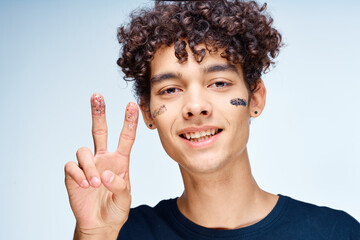 Cheerful man with curly hair cosmetics on face clean skin