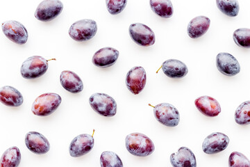Food pattern - set of purple plums, top view