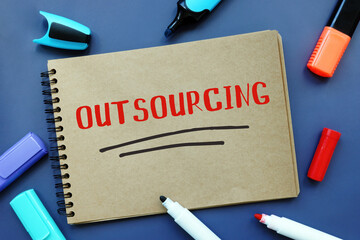Business concept about OUTSOURCING with inscription on the piece of paper.