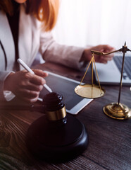 Business and lawyers discussing contract papers with brass scale on desk in office. Law, legal...