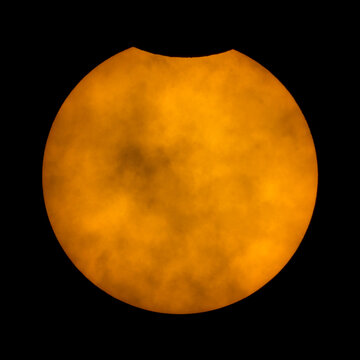 Partial solar eclipse of the Sun. On the top you can see the Moon that cover part of our star, discovering details of the south part of our satellite. At the center there are also some sunspots and cl