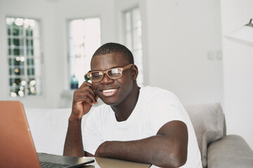 man african appearance at home in front of laptop working