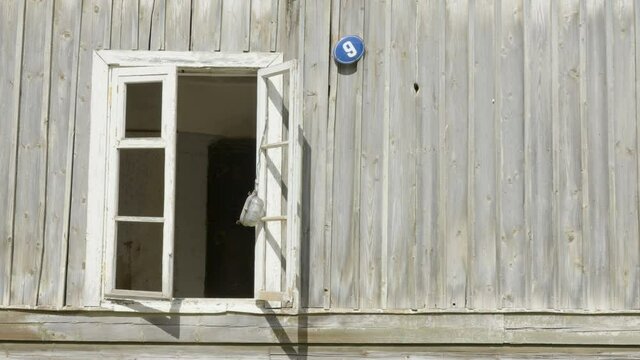 The small galss window of the wooden house with the glass jar on the ream