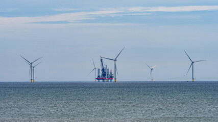 The view from the promenade in Withernsea of the North Sea with wind turbines and an offshore oil...